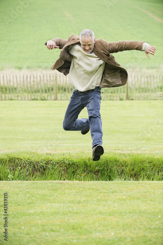 Photo: Man jumping in a field Man jumping in a field