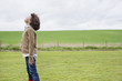 Boy daydreaming in a field