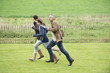 Happy family running in a field