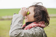 Boy looking through binoculars