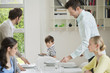 Family and guests at dining table for lunch