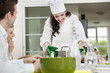 Happy female chef serving food