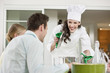 Happy female chef serving food