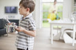 Photo: Boy carrying a saucepan Boy carrying a saucepan