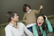 Boy pulling his sister's braid with his father looking at him
