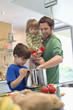 Man with his son and daughter in the kitchen