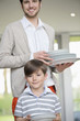 Man and son arranging plates for lunch
