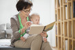 Woman with her granddaughter reading a picture book
