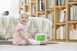 Baby girl playing with a musical block toy