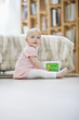 Baby girl playing with a musical block toy