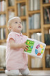 Baby girl playing with a musical block toy