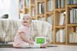Baby girl playing with a musical block toy