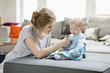 Woman teaching her daughter with a picture book
