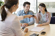 Couple receiving keys from business executive