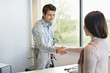 Business executive shaking hands with his client