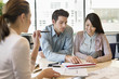 Real estate agent discussing property documents to his clients