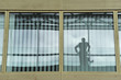 Reflection of a person on the glass of an office window