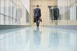 Rear view of a businessman walking in an office corridor
