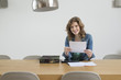 Portrait of a woman sorting out bills
