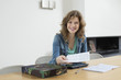 Portrait of a woman sorting out bills