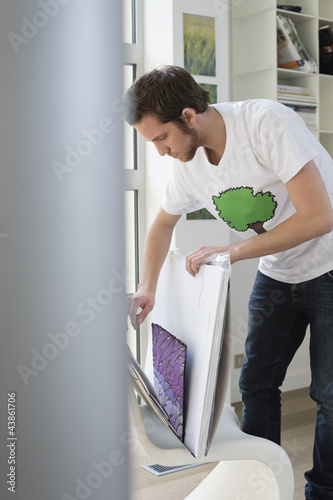 Photo: Man picking a document from a file Man picking a document from a file