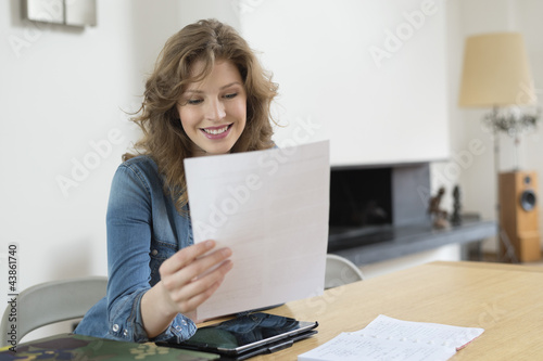 Photo: Woman sorting out bills Woman sorting out bills