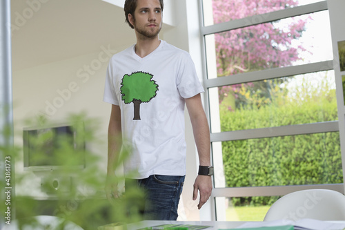 Photo: Man standing in a room Man standing in a room
