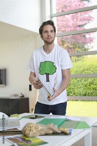 Photo: Man working on environment awareness posters Man working on environment awareness posters