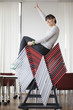 Businesswoman sitting on pileup chairs in an office