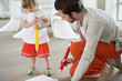 Man and his daughter drawing with large pencils