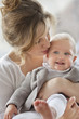 Close-up of a woman kissing her baby