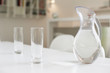 Jug of water and glasses on a dining table