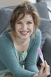 Woman looking happy after checking her pregnancy test