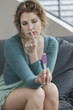 Woman looking sad after checking her pregnancy test