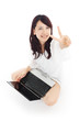 Photo: Beautiful young woman using a laptop computer. Beautiful young woman using a laptop computer.