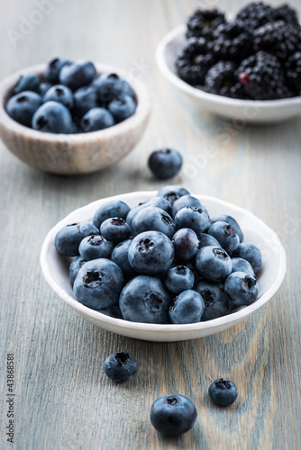 Photo: Blueberries and blackberries in small bowls Blueberries and blackberries in small bowls