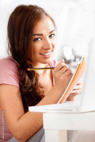 Photo: Close-up portrai of an attractive young student smiling Close-up portrai of an attractive young student smiling
