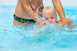 Photo: Child having fun in water with mom. Child having fun in water with mom.