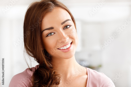 Photo: Close-up portrai of an attractive young woman smiling Close-up portrai of an attractive young woman smiling
