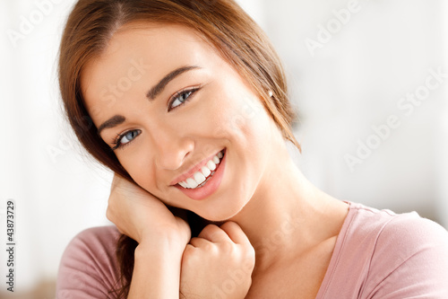 Photo: Close-up portrai of an attractive young woman smiling Close-up portrai of an attractive young woman smiling