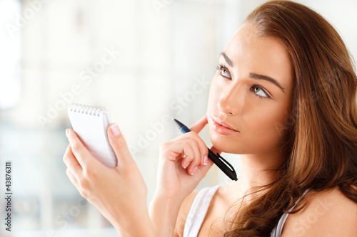 Photo: Attractive young student planning ahead Attractive young student planning ahead