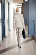 rear view of young businesswoman walking to office