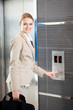 beautiful young businesswoman using elevator
