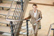 cute young businesswoman walking up stairs