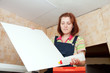 Girl glues ceiling tile