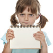 little girl holding empty white notebook