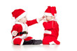 two funny small kids in Santa Claus clothes isolated on white ba