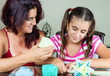 Mother and daughter making origami at home