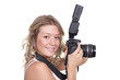 Cheerful woman shooting with a camera against white background