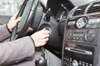Woman caucasians hand starting a car engine with ignition key